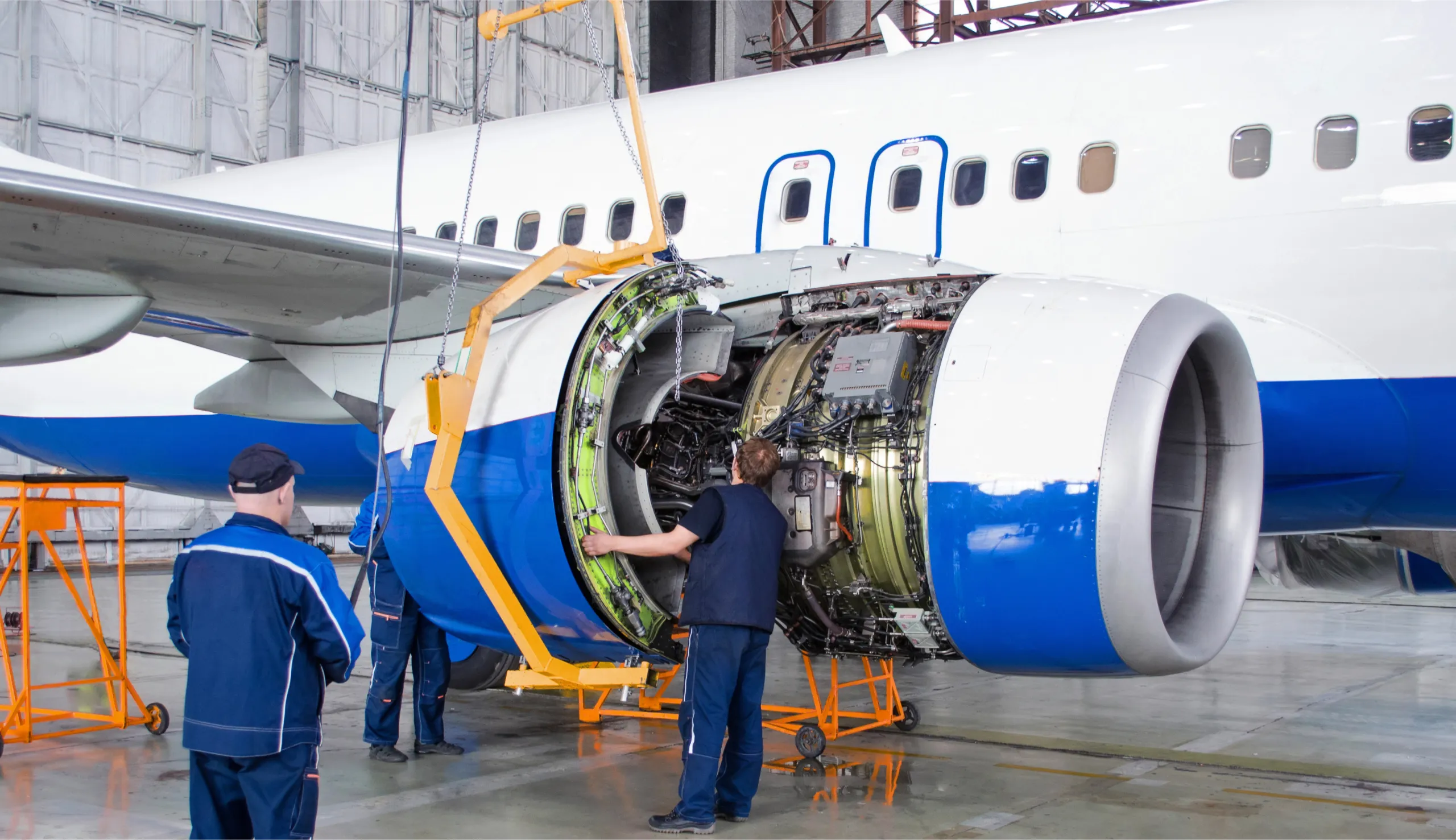 Two aviation mechanics working on an engine