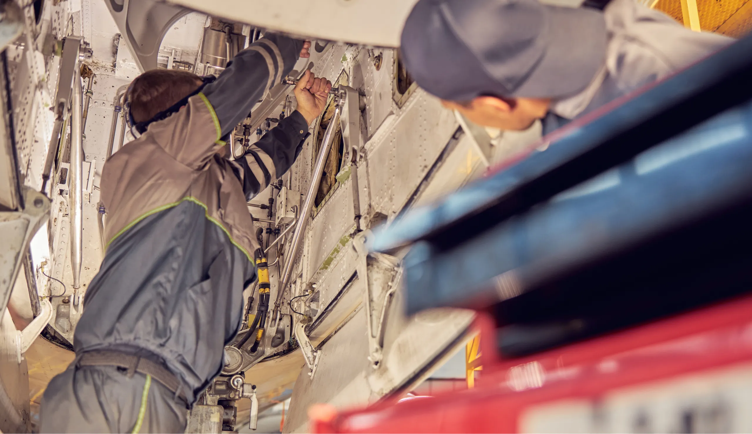 Two aviation mechanics working on an engine