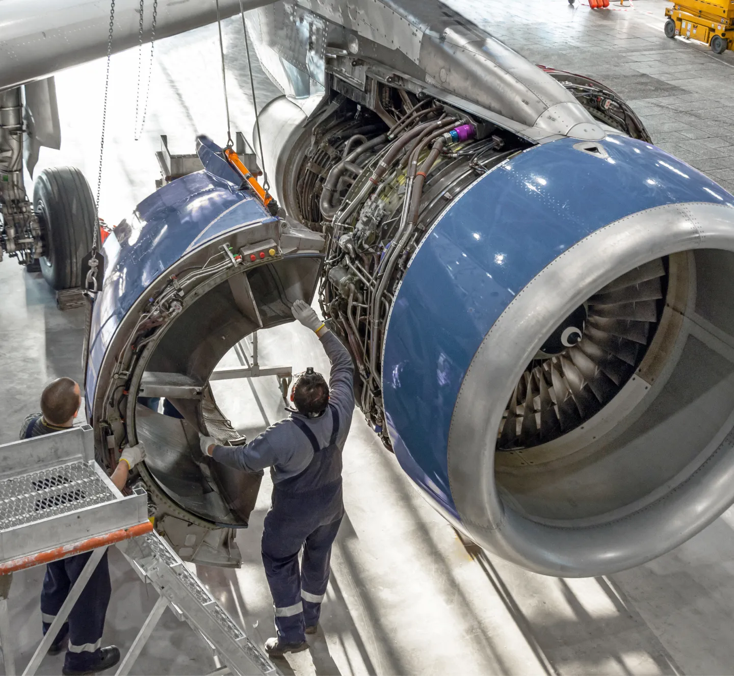 home intro Two aviation mechanics assessing a commercial airplane engine