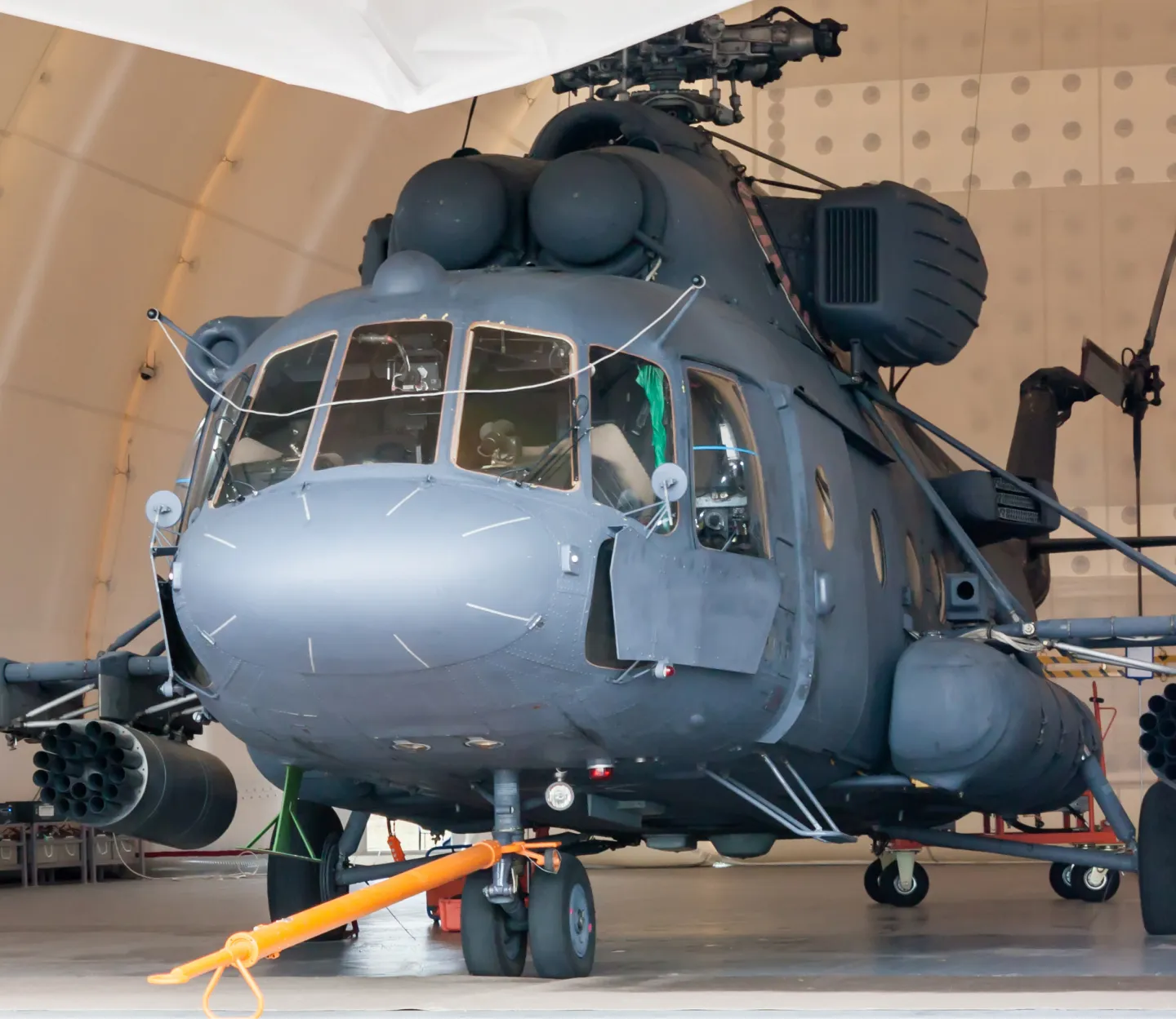 Military helicopter parked inside a military hangar